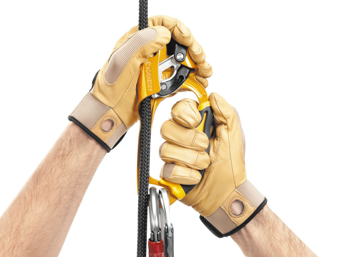 Petzl Ascension handled ascender with ergonomic grip and bright yellow handle for right-handed users, mounted on a rope